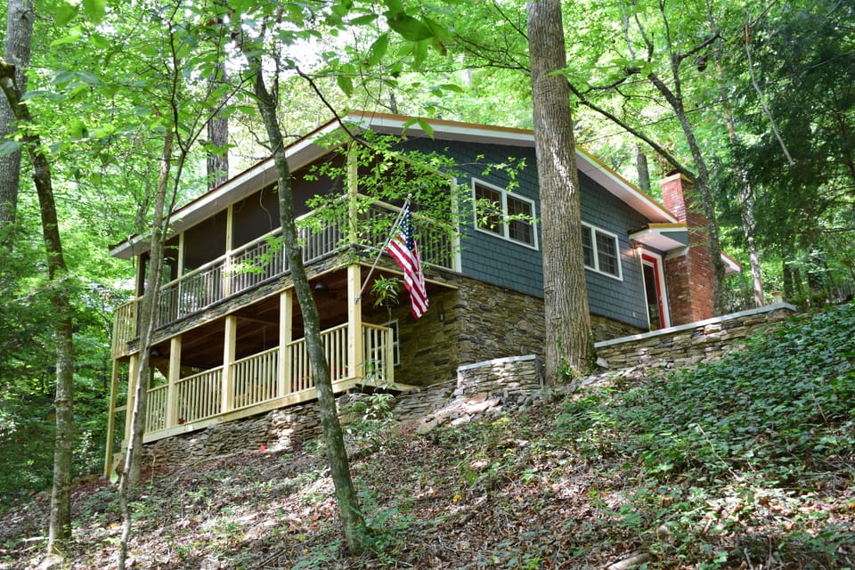 Surrounded by trees and 50’ from Cane Creek. 