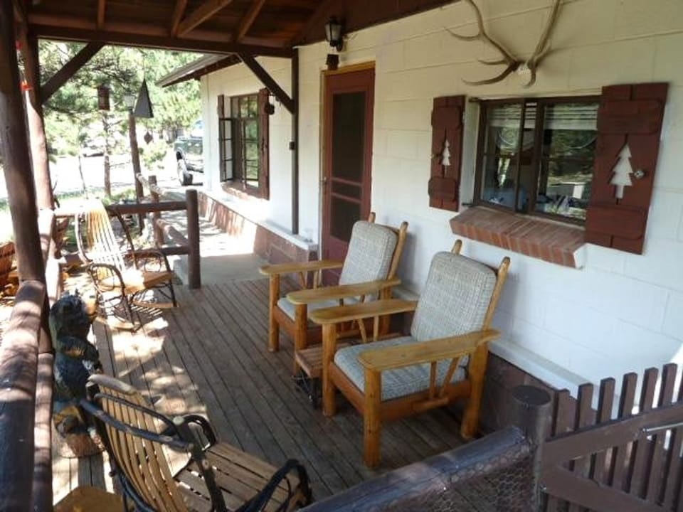 Front porch with 2 rocking chairs and 2 large cushioned chairs