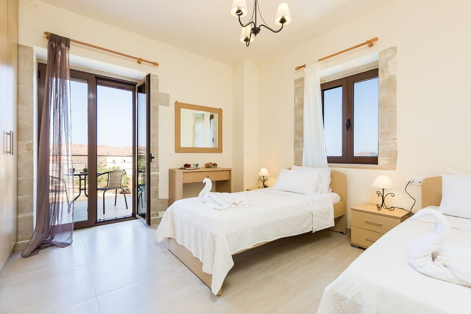 The first twin bedroom has a balcony with patio furniture!