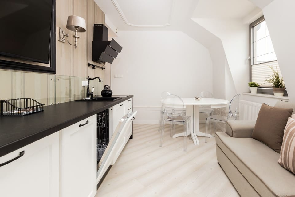 The integrated living and dining space, showcasing its airy layout, large windows, and modern furniture.