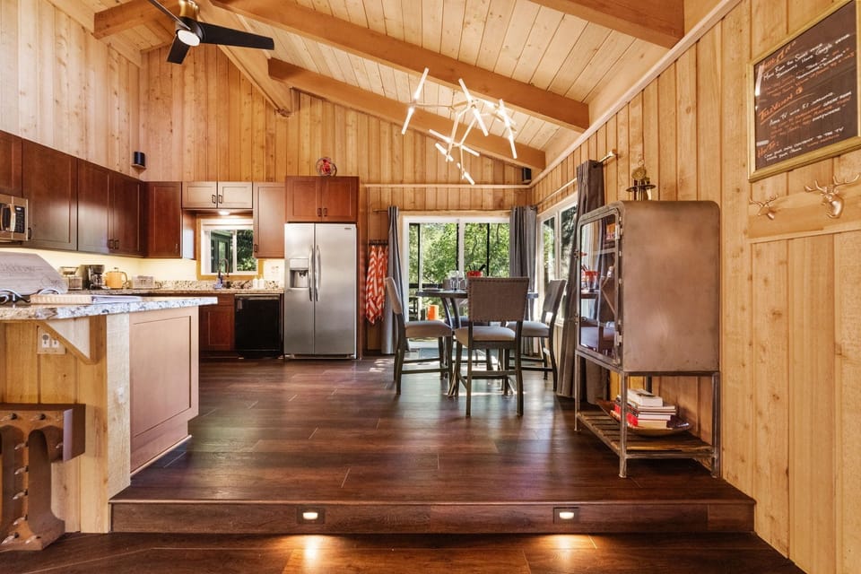 The kitchen is fully equipped and features both a dining table - The kitchen is fully equipped and features both a dining table and a breakfast bar for additional seating.