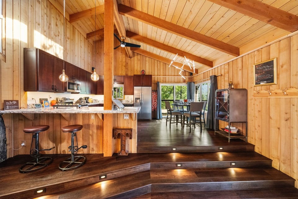 The kitchen is fully equipped and features both a dining table - The kitchen is fully equipped and features both a dining table and a breakfast bar for additional seating.