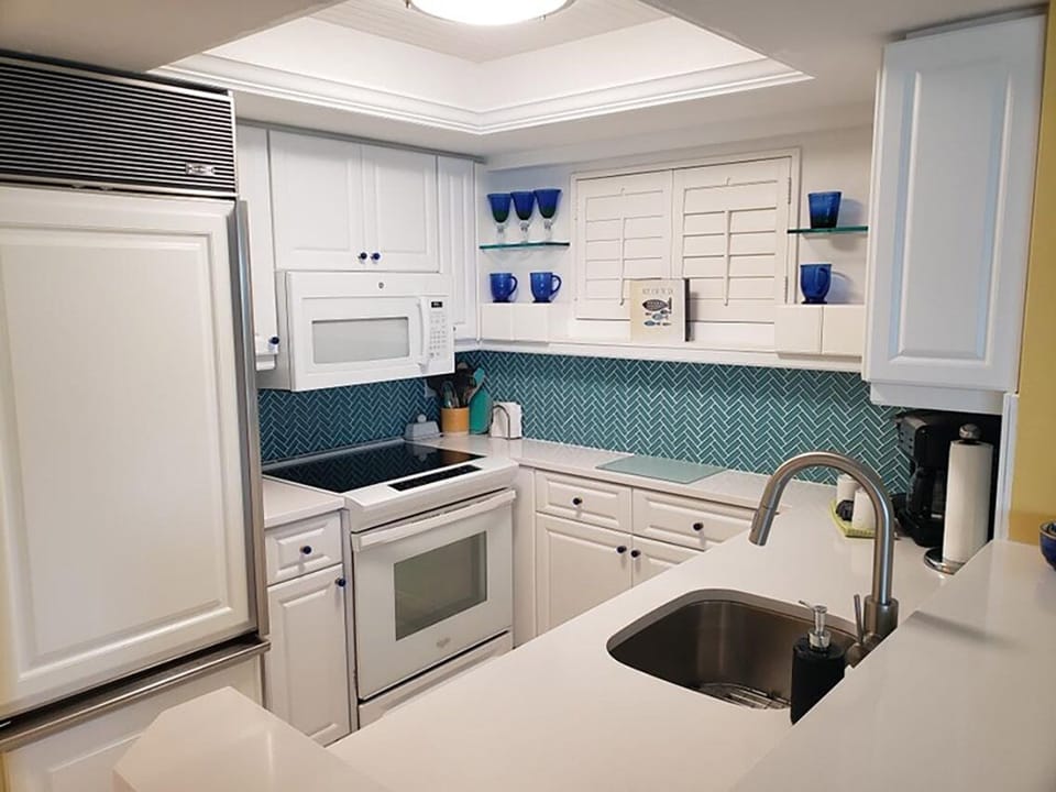 New countertops, glass tile backsplash and stainless-steel sink