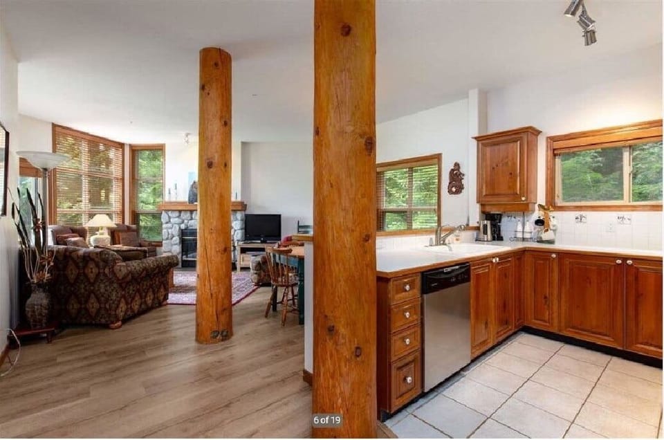 Spacious open concept ideal for entertaining.Large windows view of forested area