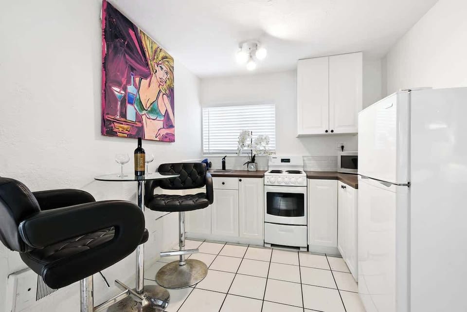 Full kitchen in the Studio unit. Cooking range shown in this photo is replaced by a dual electric stove and an air fryer.