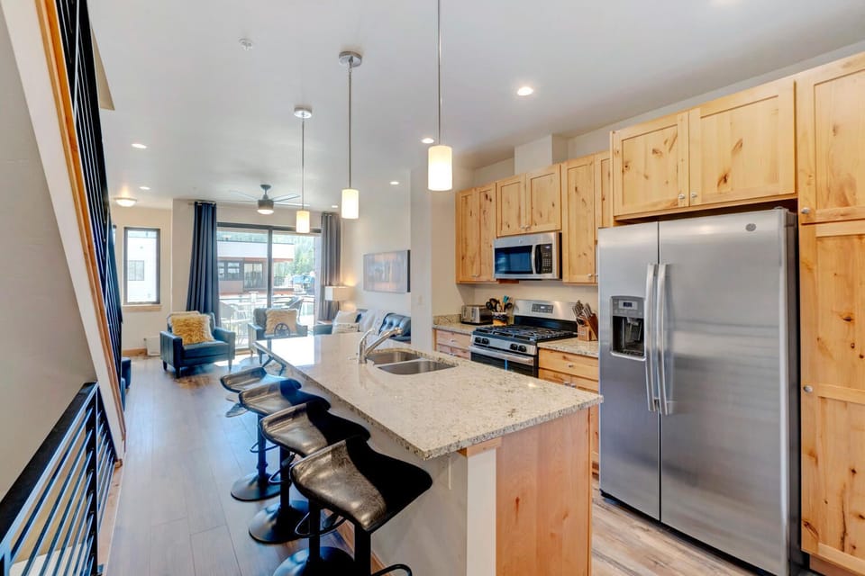 Kitchen with Island, Stools, Refrigerator, and Microwave