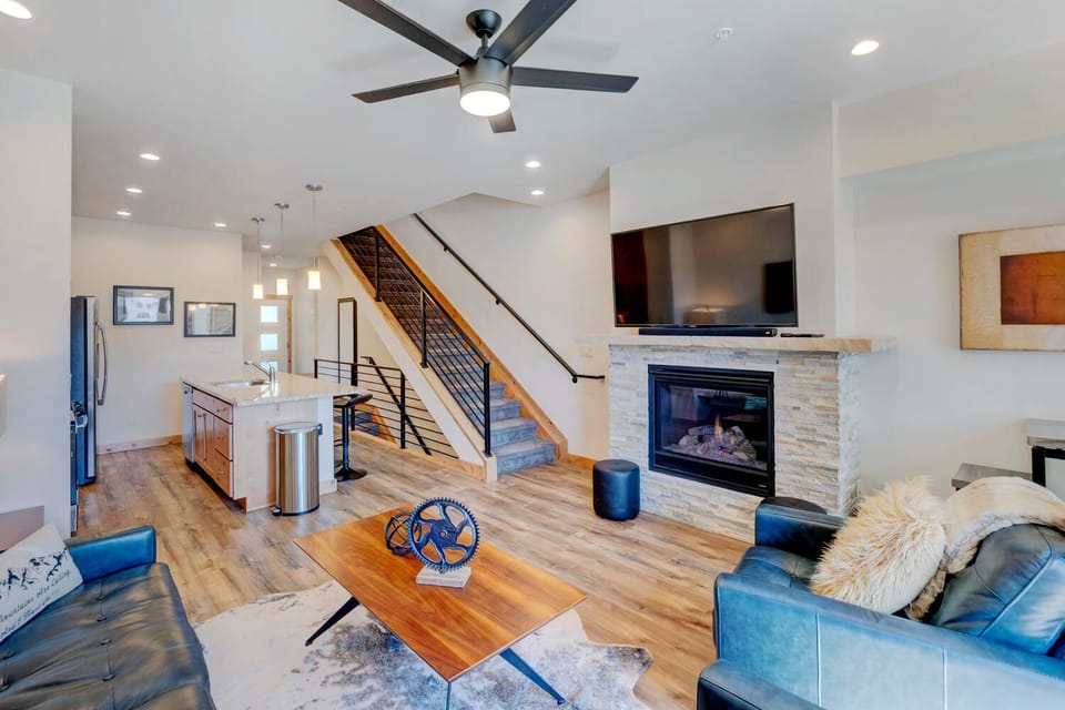 Living Room with Arm Chair, Coffee Table, Ceiling Fan, TV, Fireplace