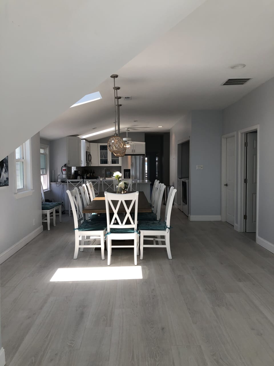 Dining table shown with 10 chairs... looking from living room to kitchen