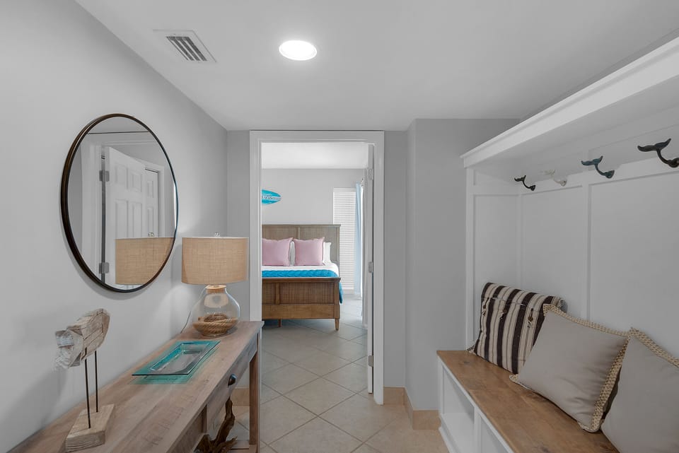 Entry with seating beach and entry to guest room.