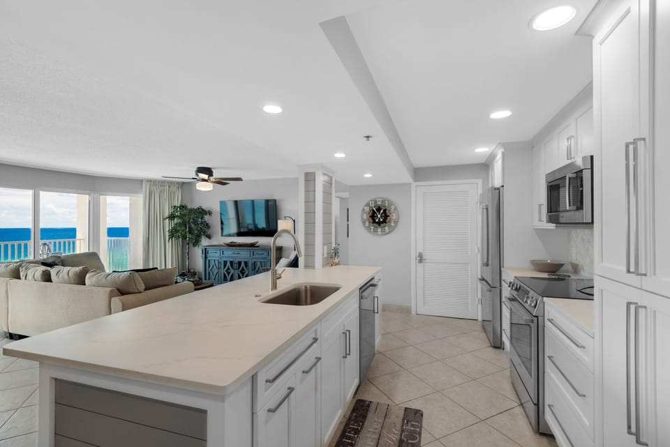 Chic, modern kitchen with quartz counters, new appliances, large island.