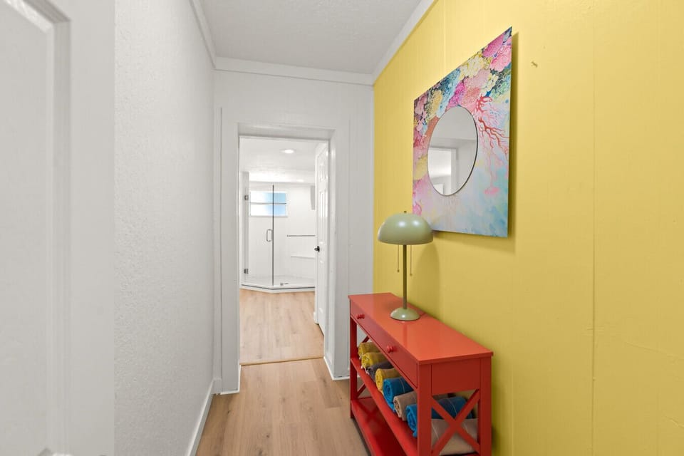Siesta Key Beach hallway with bold color, abstract art, and modern bath access