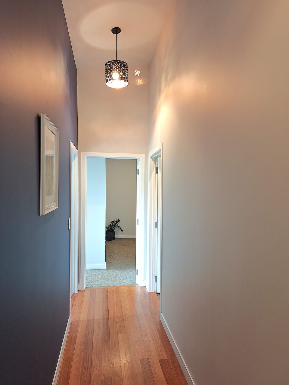 Hallway from living to bedrooms with raised ceiling