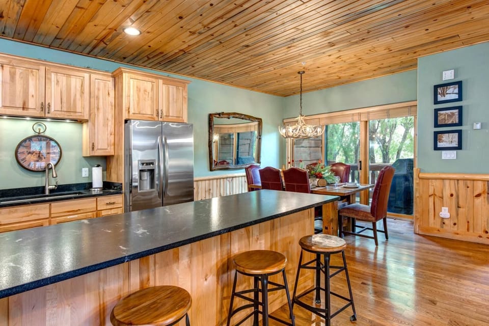 This fully equipped kitchen features appliances, bar seating, and plenty of prep space.