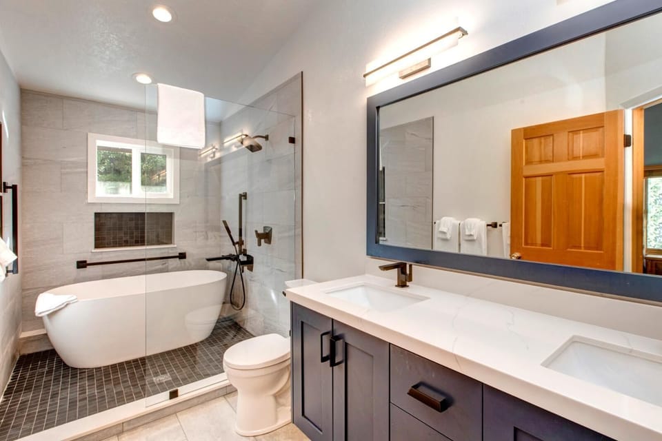 Your primary ensuite features a walk-in shower, soaking tub, and modern double vanity with granite counters.