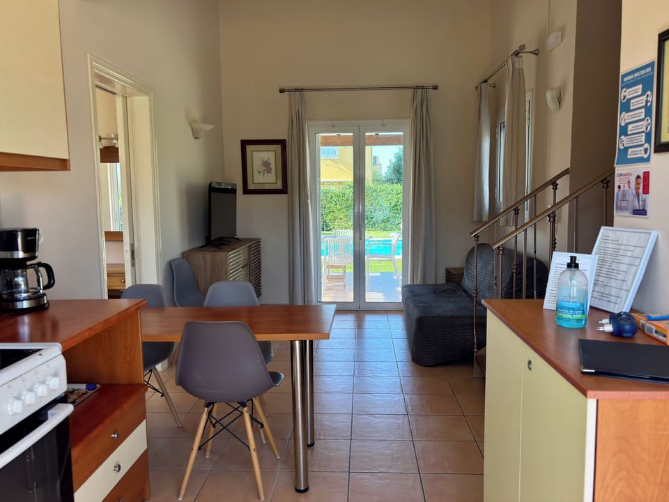 Open plan kitchen, a ceiling fan, and direct access to the pool and patio