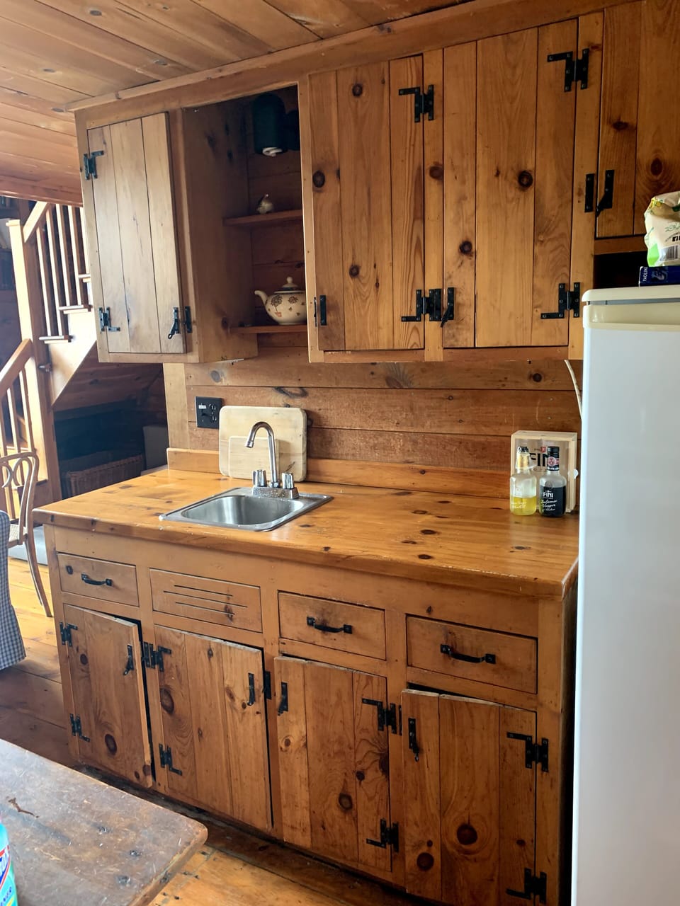 Fully equipped kitchen, includes full size fridge, stove, and coffee machine. 