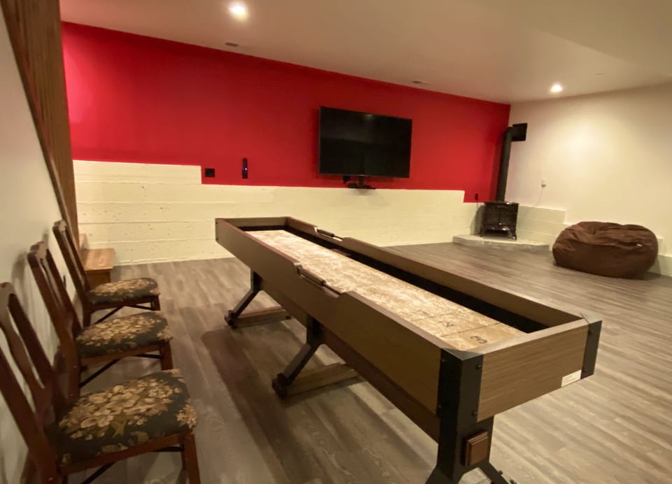 Game Room shuffleboard table and TV