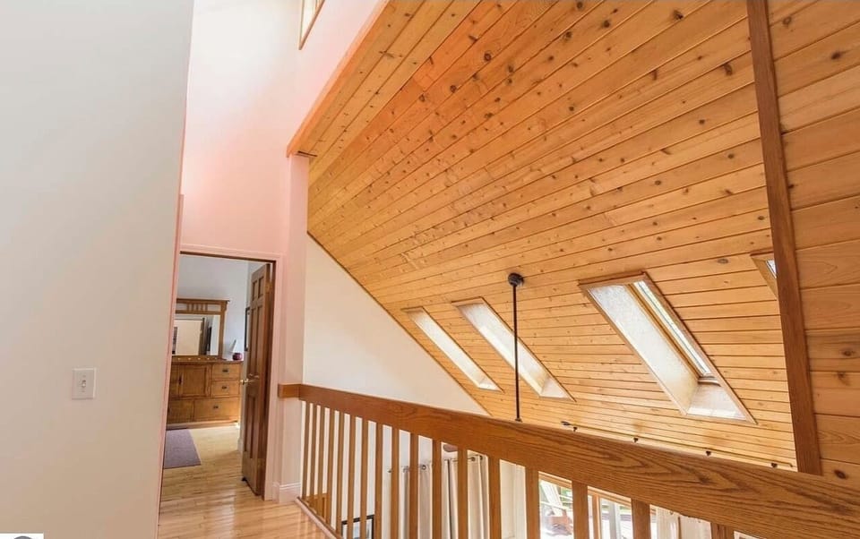 Upstairs walkway leading to 2 bedrooms and a bathroom  