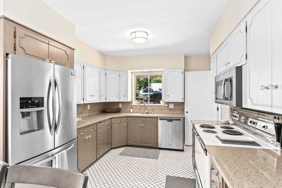 Stunning large and functional kitchen on main level mixing old world charm with modern convenience featuring tile floors and upgraded appliances.