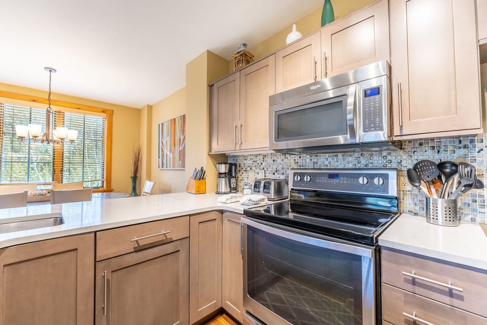 Cook memorable meals in your fully equipped kitchen with stainless steel appliances and bright natural light streaming in.