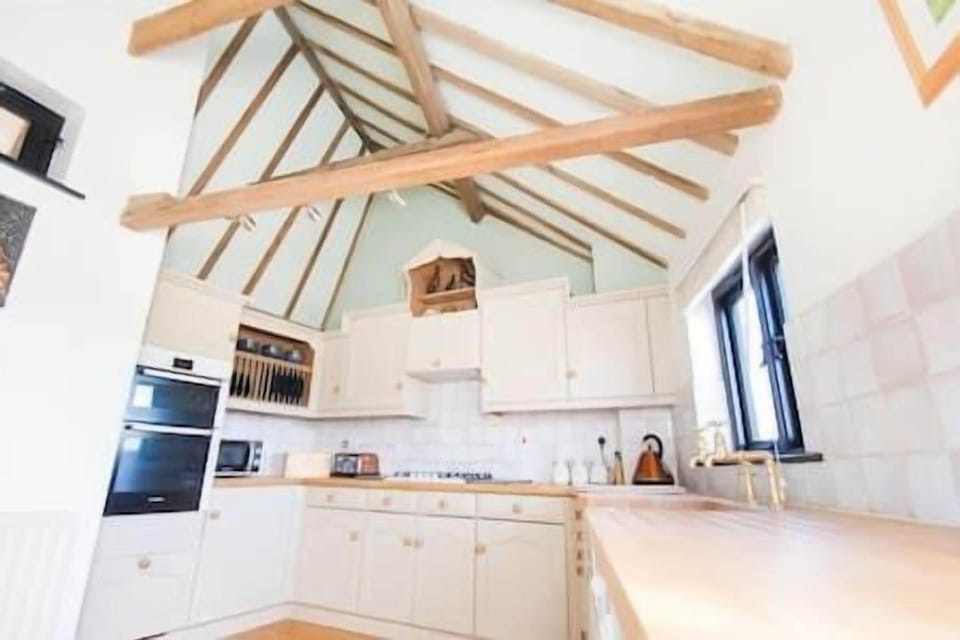 A real feature kitchen complete with ceramic Belfast sink, dishwasher, cooker, hob, fridge, freezer, microwave, kettle, toaster and coffee machine!
