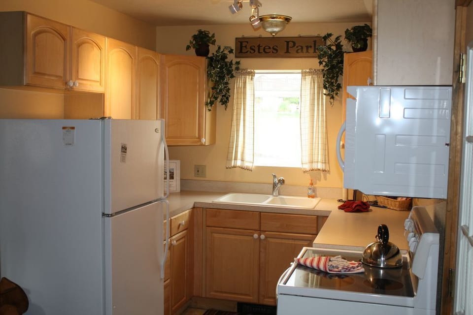 Kitchen with electric stove, microwave, dishwasher, refrigerator, keurig and coffee pot, pots/pans/c