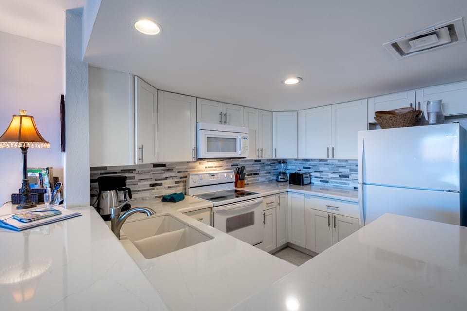 Spacious Kitchen with plenty of counter top and comforotable stools for a nice seating/eating option