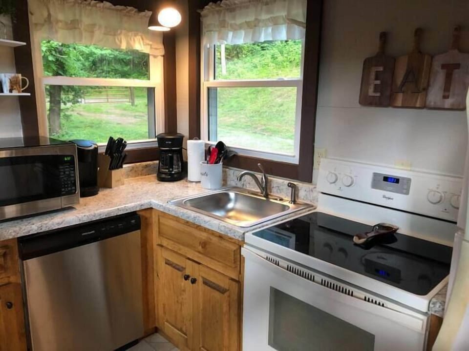 Cook, eat, repeat: This kitchen is complete with cookware, dishes, and utensils.