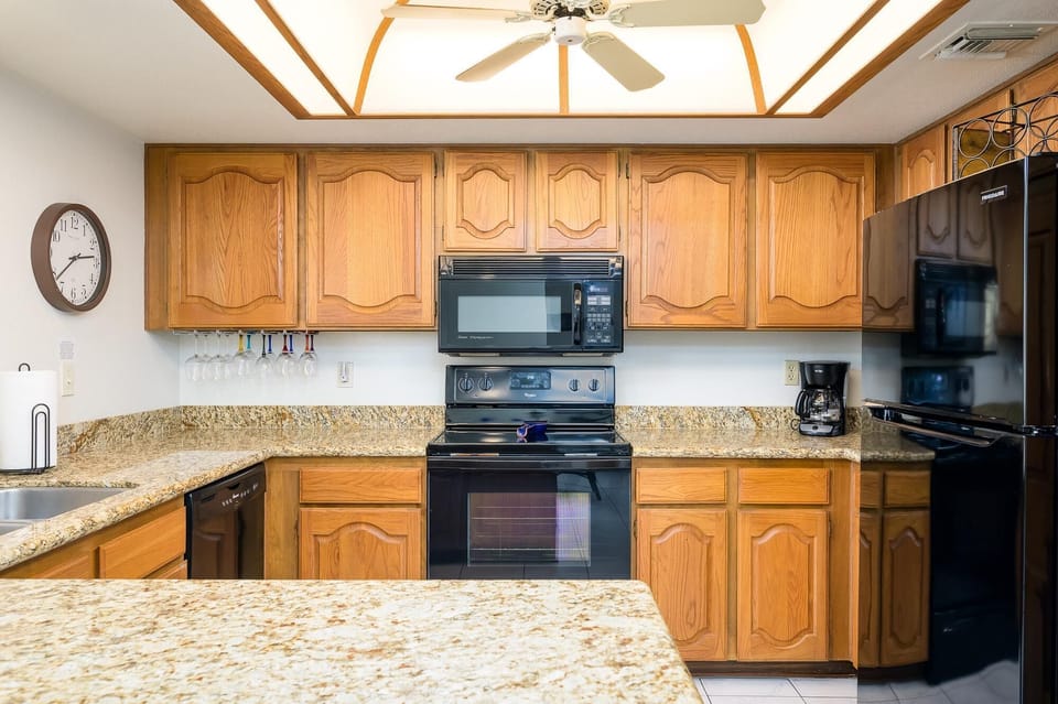 Fully stocked kitchen with granite counter tops.
