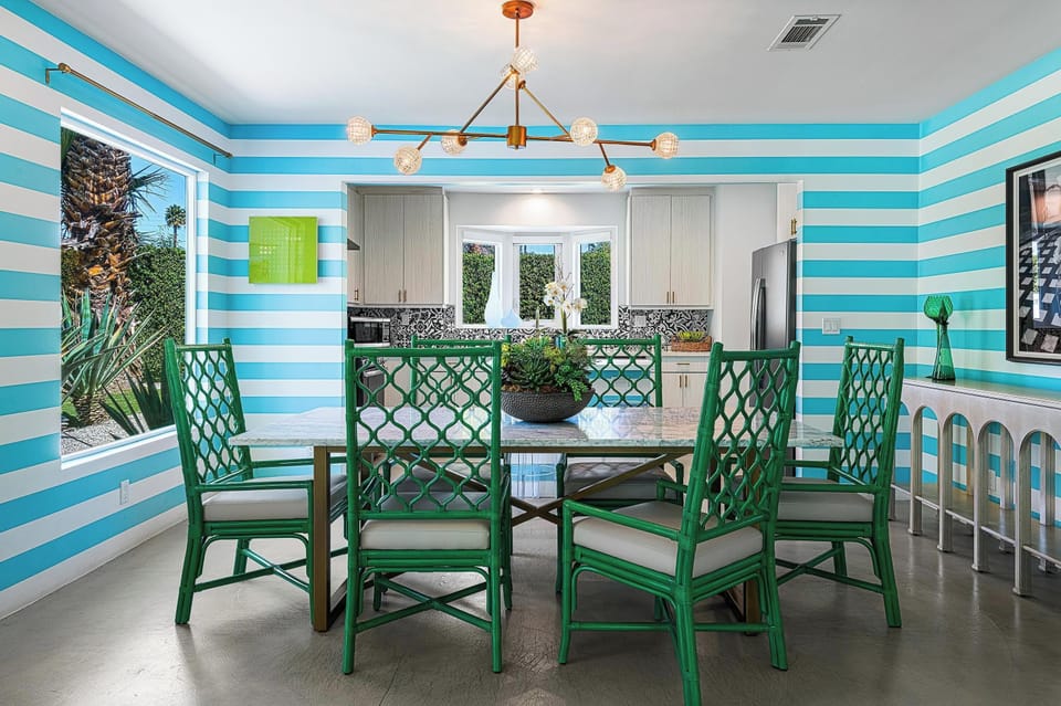 Dine in style in our chic mid-century dining room! With sleek furnishings & vintage charm, this space invites you to savor meals with elegance. Gather around the table & enjoy a blend of comfort and sophistication for unforgettable dining experience.