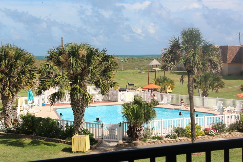 Watch the kiddos at the pool from your private balcony