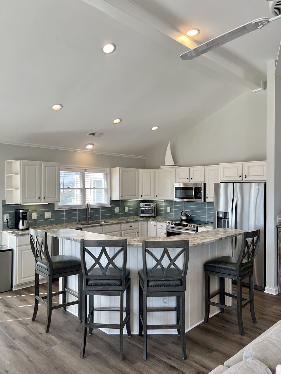 Granite counter tops, stainless steel appliances, well-stocked Kitchen. 