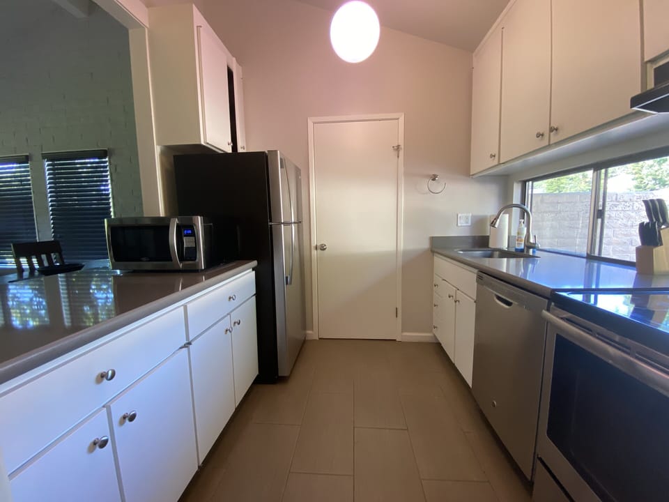 Full kitchen with oven, stove, microwave, toaster oven and coffee maker. 