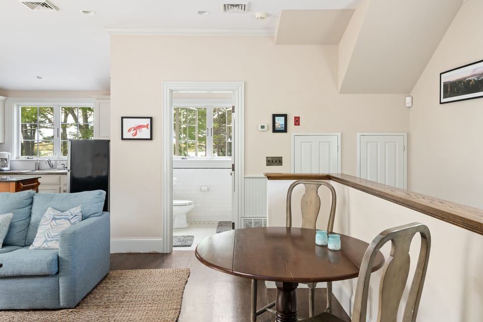 View of table and chairs with door leading to the bathroom
