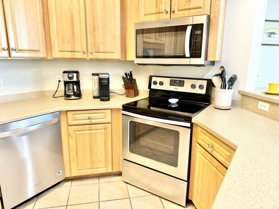 Stainless steel appliances in the kitchen. Both style coffee makers for use.