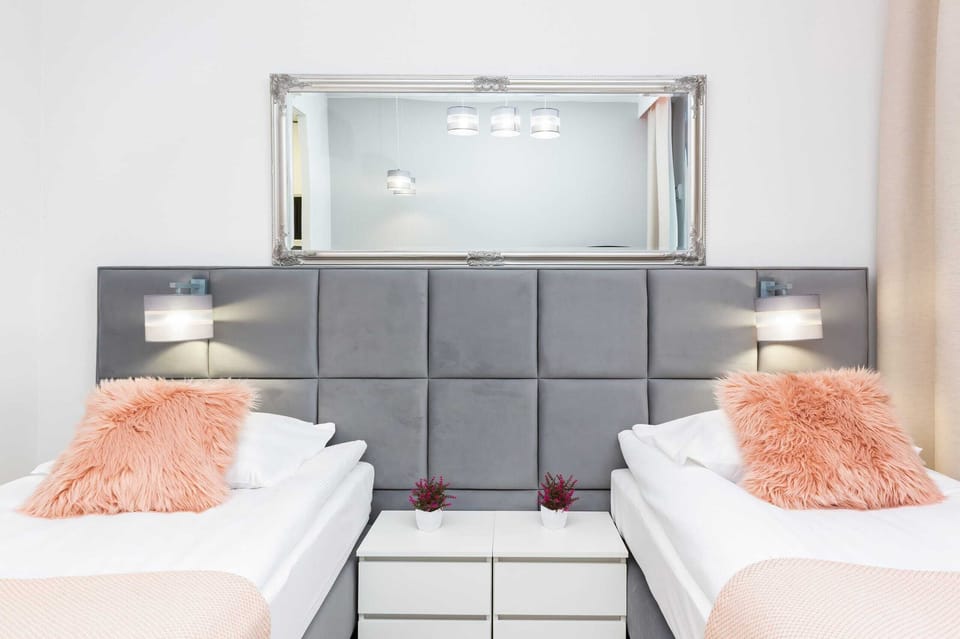 Close-up of two single beds with decorative pillows. 