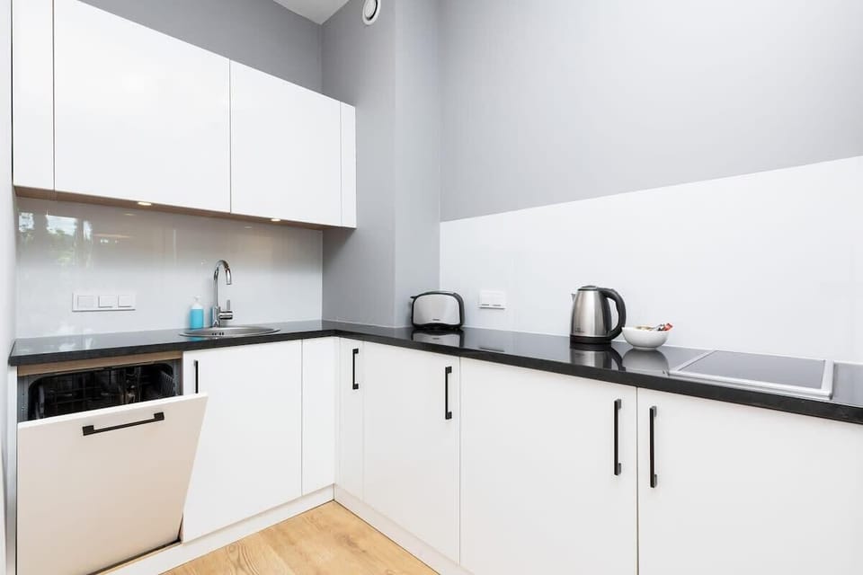 A similar view as previous, emphasizing the bright and airy kitchen with integrated lighting and modern fixtures.