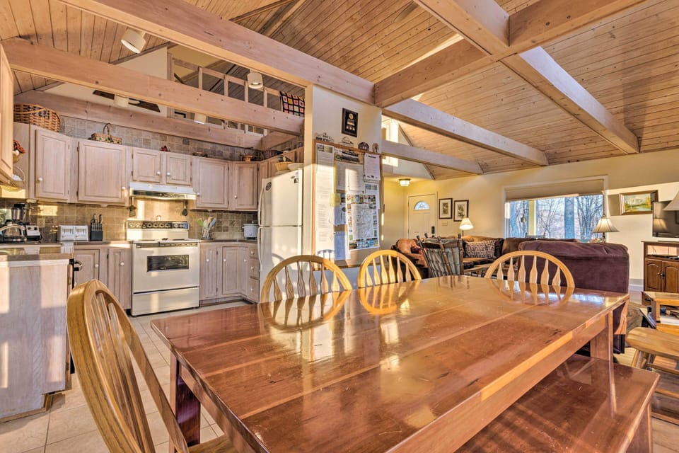 Dining table, with kitchen to the left and the living room on the right