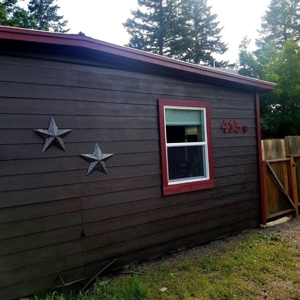 Exterior of house and parking. Entrance to the front door is through the gate.