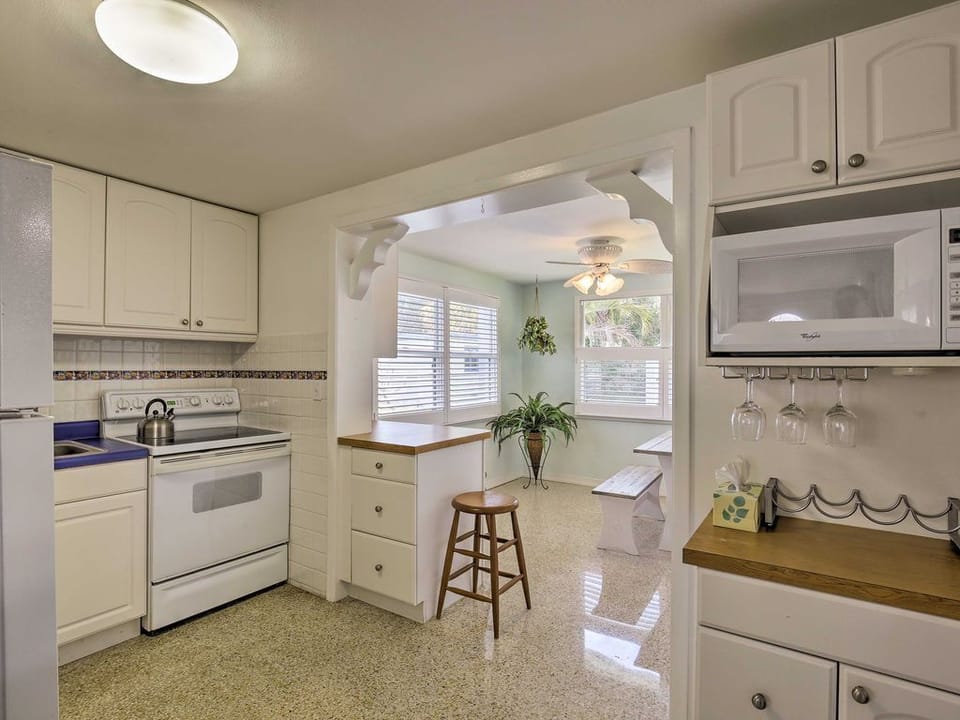 The bright white cabinets have space to store all of your cooking supplies.