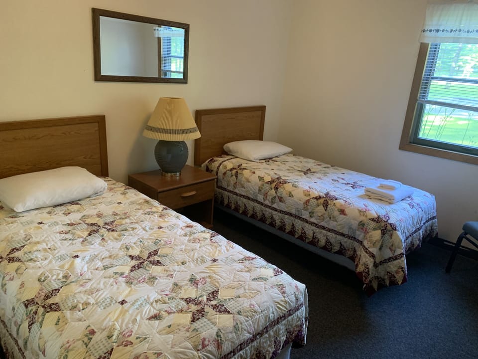 one of four bedrooms with two beds each