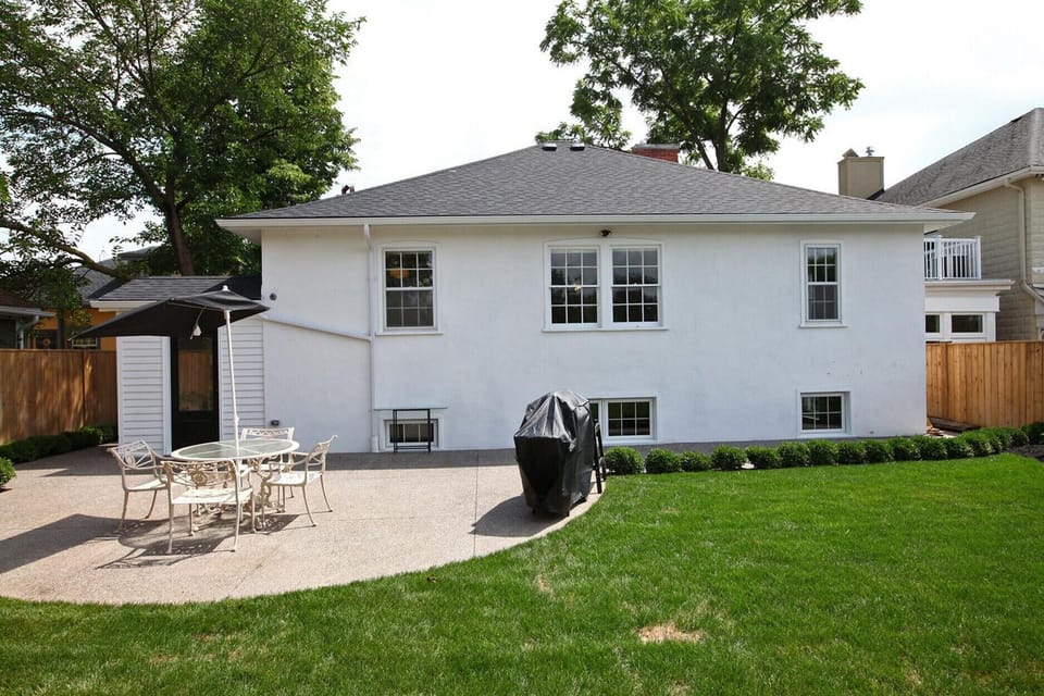 Backyard include a small patio with table for outdoor dining and propane BBQ