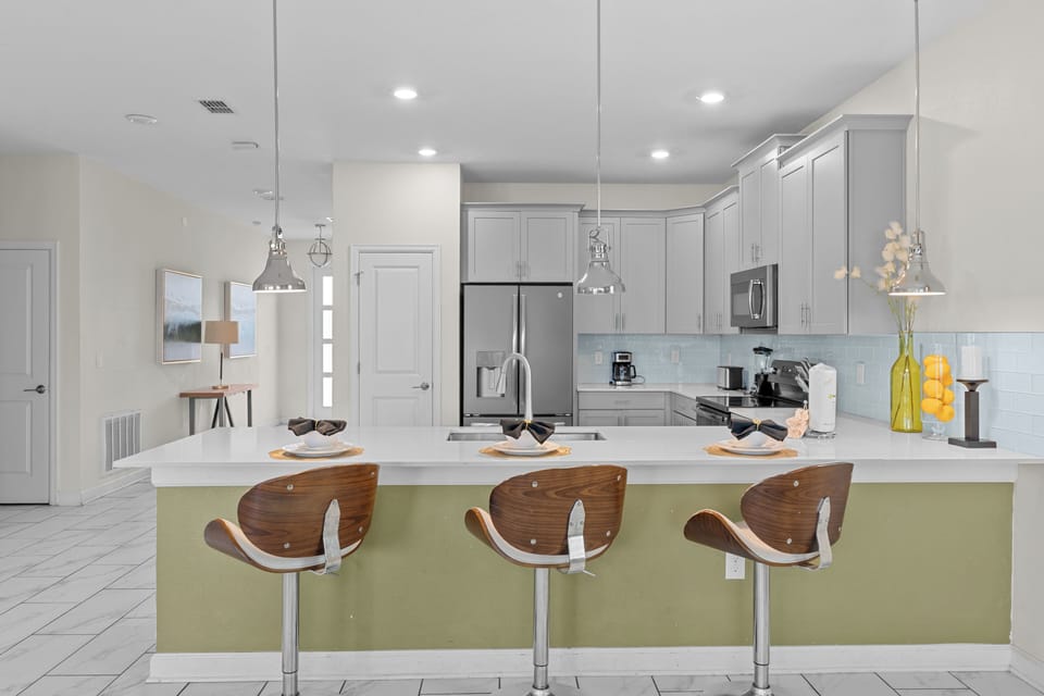 Cook with ease in your modern kitchen featuring stainless steel appliances, granite countertops, and a stylish breakfast bar.