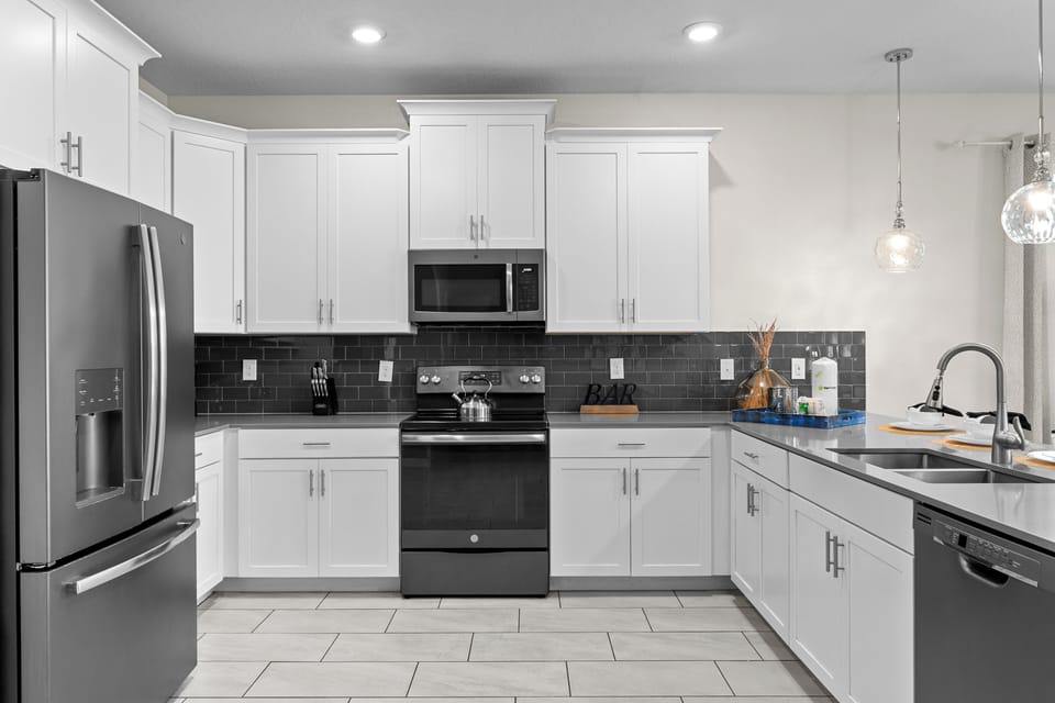 Your fully equipped kitchen awaits with modern appliances and sleek countertops for home-cooked meals during your stay.
