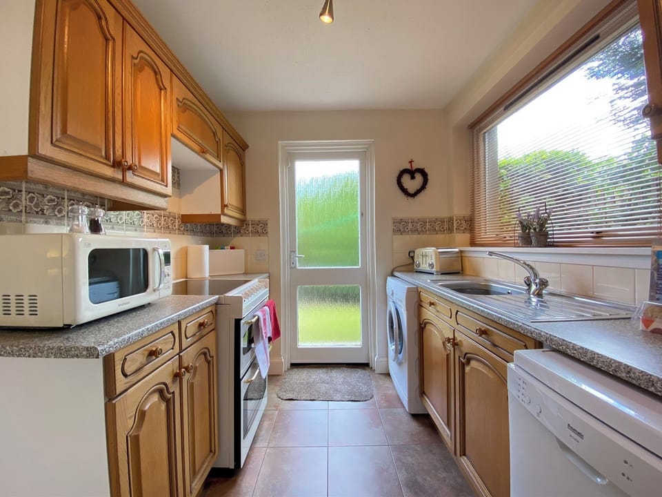 Fully fitted kitchen with access to back garden and patio 