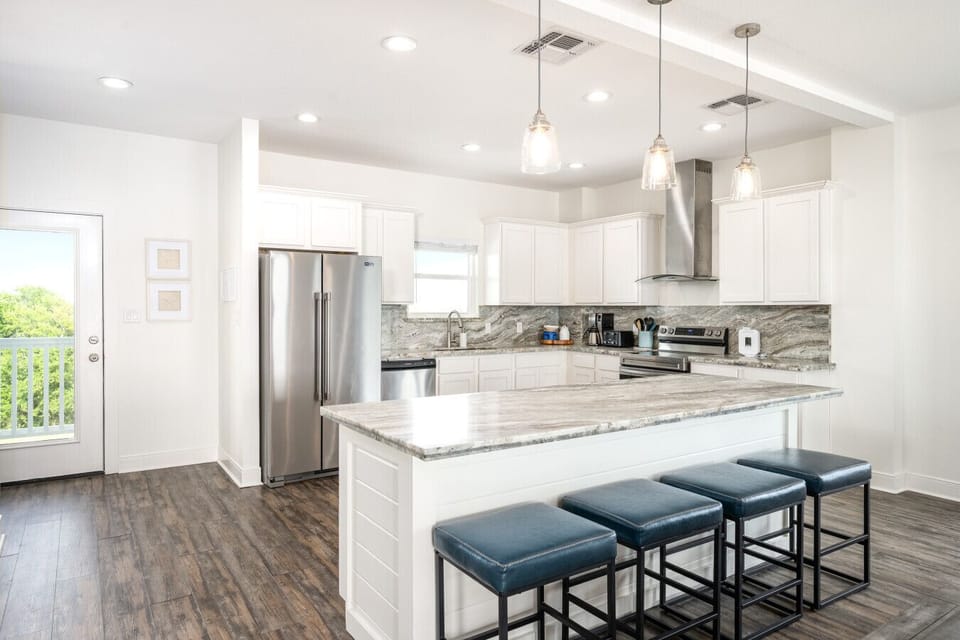 Spacious kitchen layout with seating and easy flow to living areas