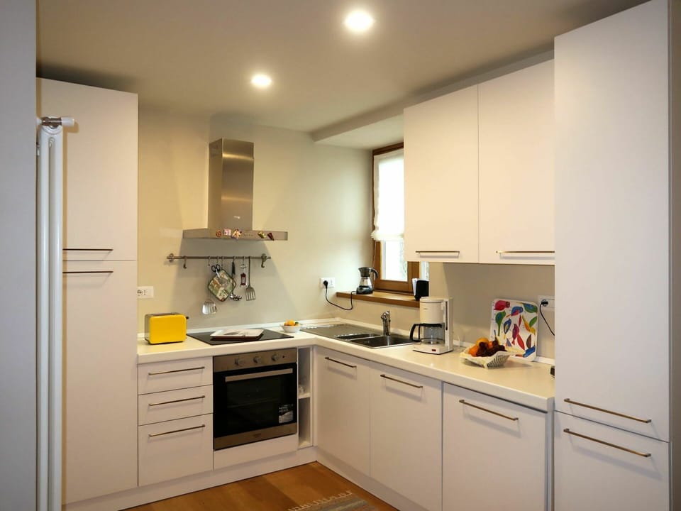 Room, Furniture, Cabinetry, Countertop, Kitchen, Property, Yellow, Interior Design, Building, Major Appliance