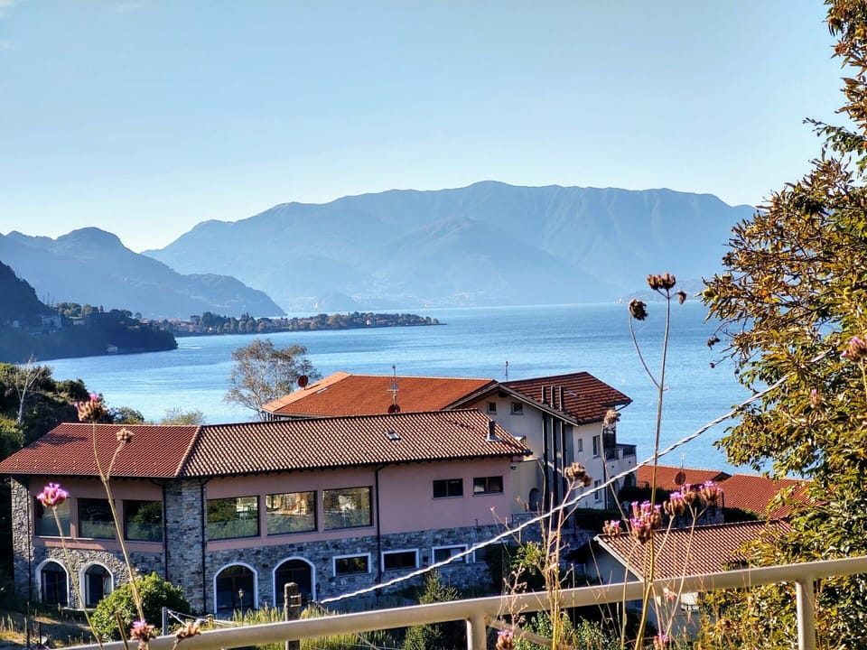 Sky, Water, Mountain, Building, Natural Landscape, Azure, Plant, Highland, House, Lake