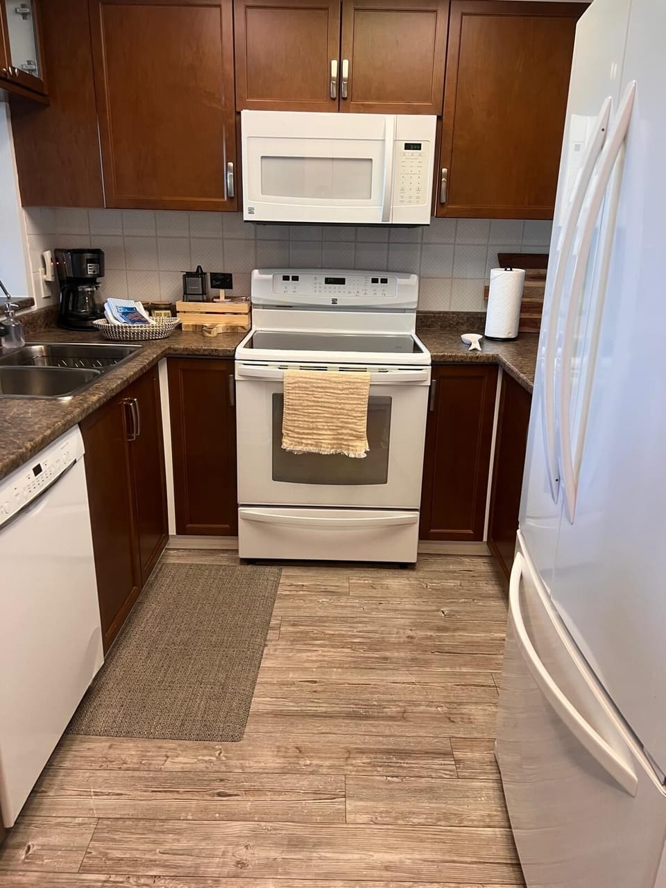 Dishwasher, induction cooktop stove, double door fridge with water dispenser.