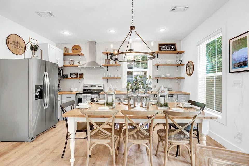 Discover the charm of open shelving in the kitchen and a large table for eight, perfect for gatherings.
